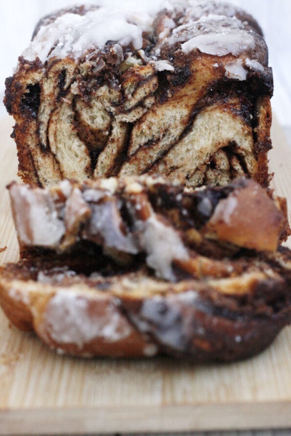 Nutella babka sliced on a wooden board.