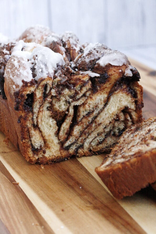 Nutella babka sliced open on a wooden board.