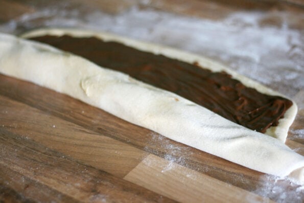 rolling up dough filled with Nutella.