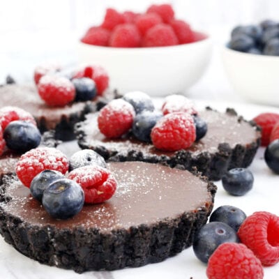 no bake chocolate tarts with berries on top.