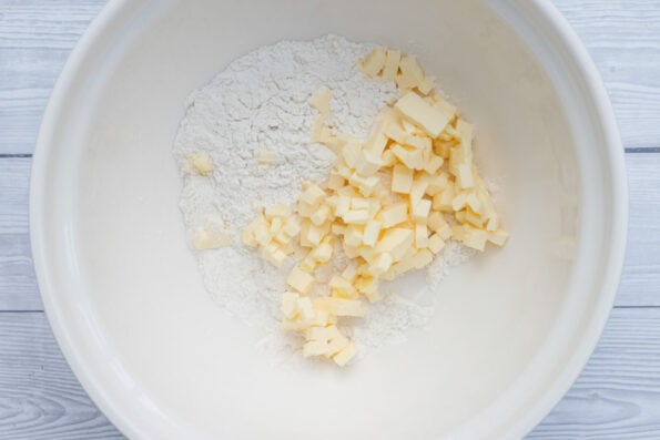 butter cut into pieces and flour in a mixing bowl. 