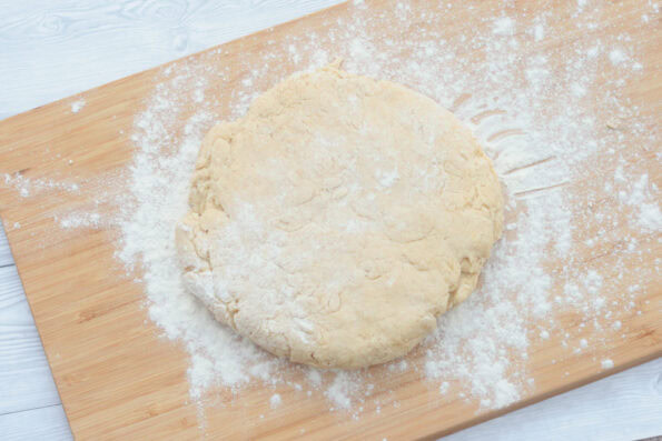 shortcake dough patted down on a wooden board.
