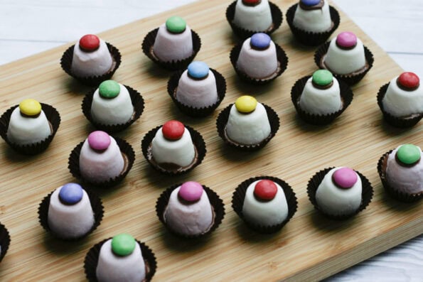 marshmallow top hats on a wooden board.