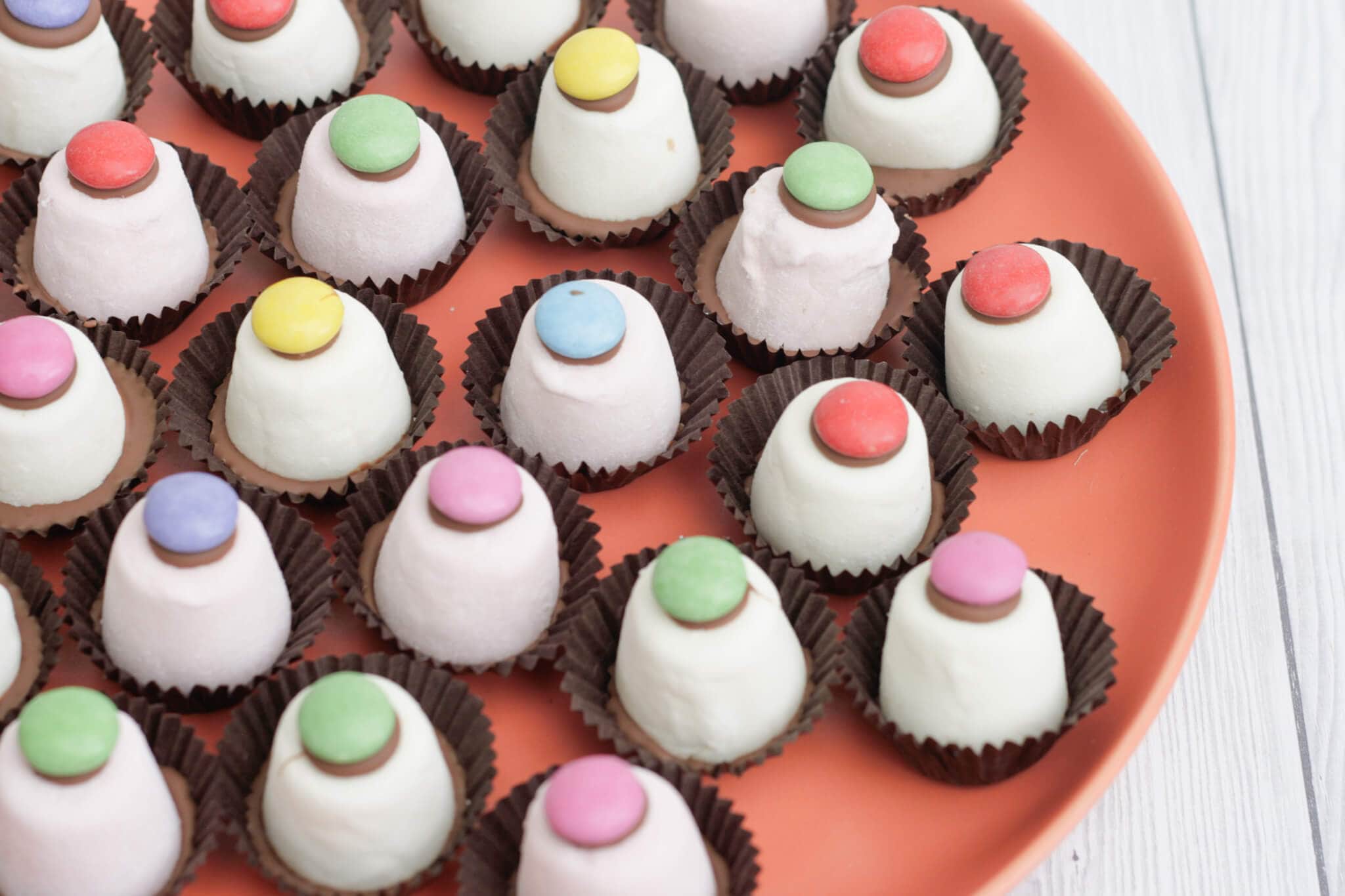 marshmallow top hats on an orange plate.