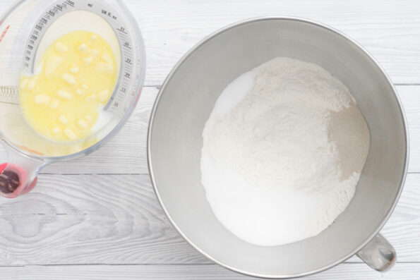 butter and milk in a jug next to flour in a mixing bowl.