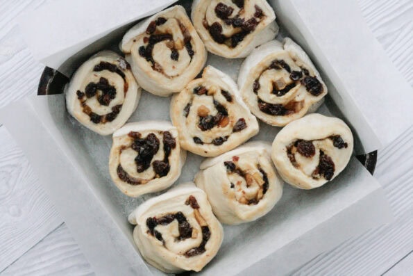 mincemeat cinnamon rolls in a baking tin before being baked.