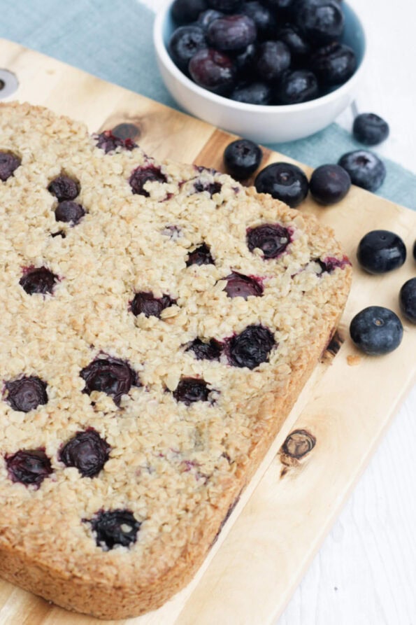 blueberry flapjacks on a wooden board.