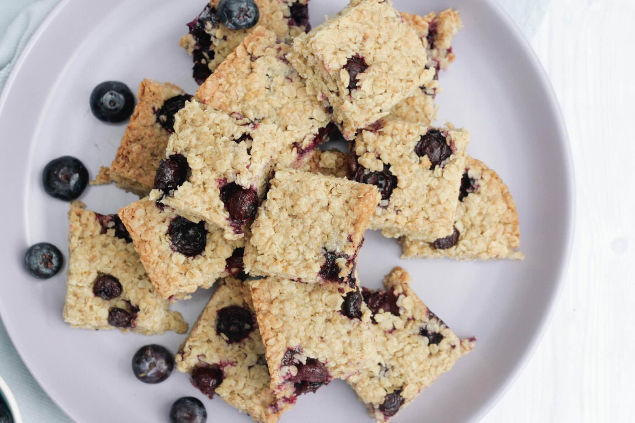 blueberry flapjacks on a lilac plate.