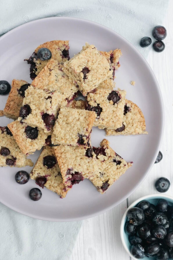 blueberry flapjacks on a lilac serving plate.