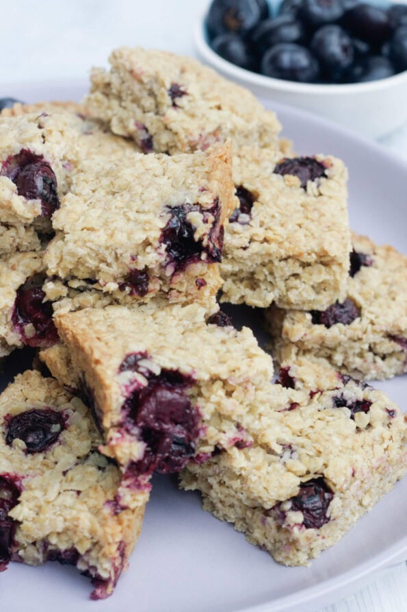 blueberry flapjacks on a lilac serving plate.
