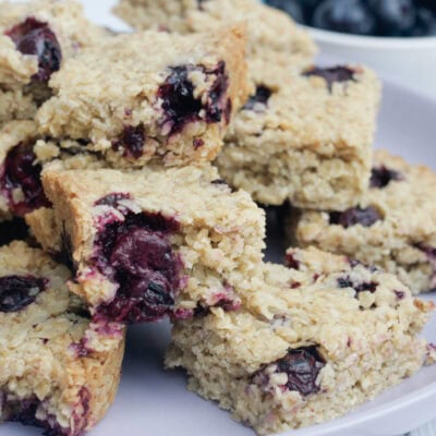 blueberry flapjacks on a lilac serving plate.