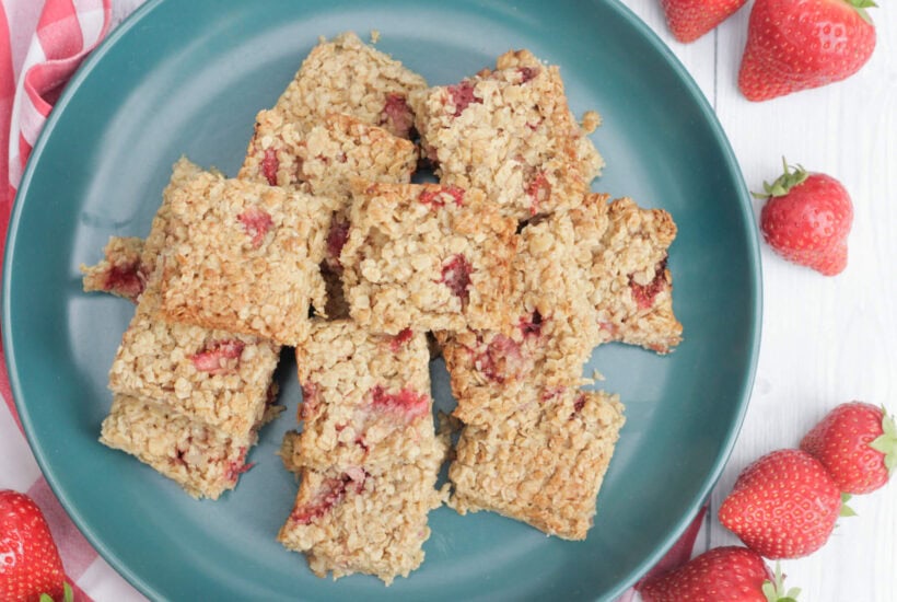 strawberry flapjacks on a green plate.