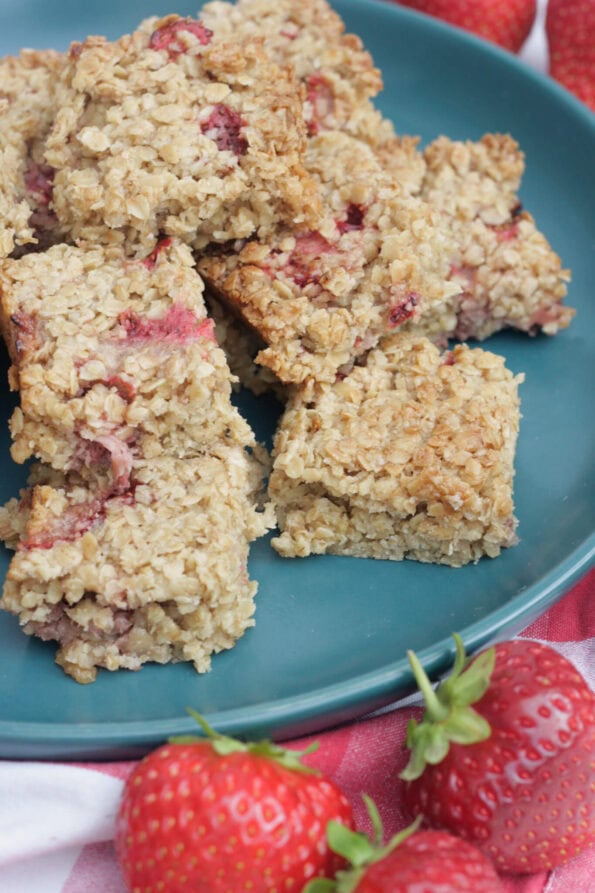 strawberry flapjacks on a green plate.