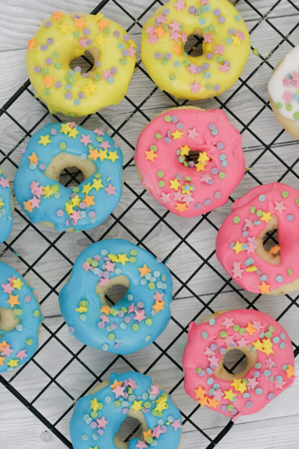 colourful baked doughnuts on a wire rack.