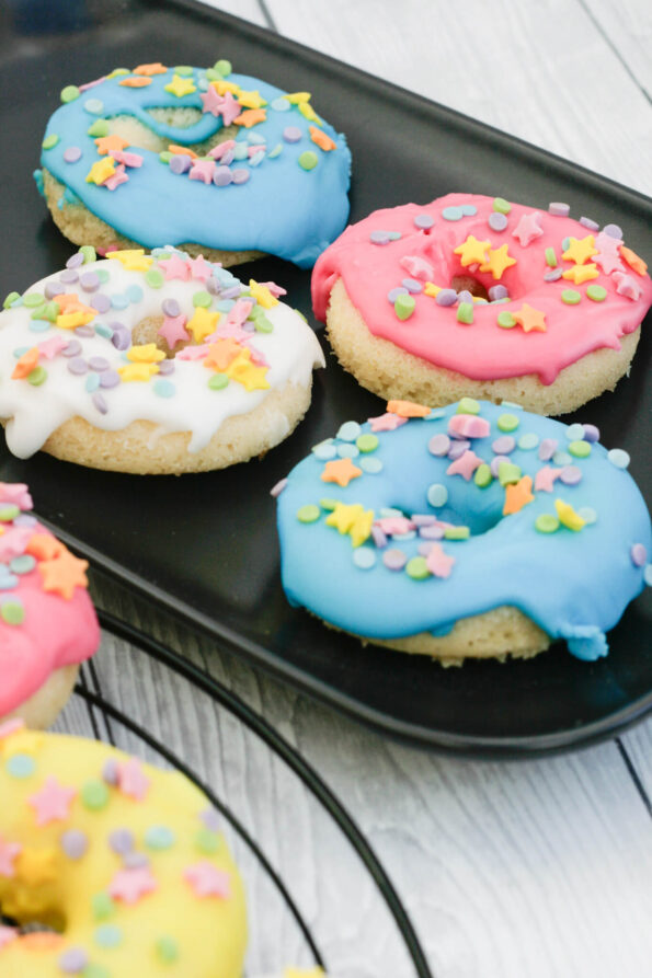 baked doughnuts on a black serving plate.