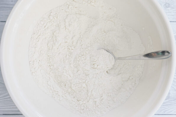 flour, sugar and baking powder mixed together in a bowl.