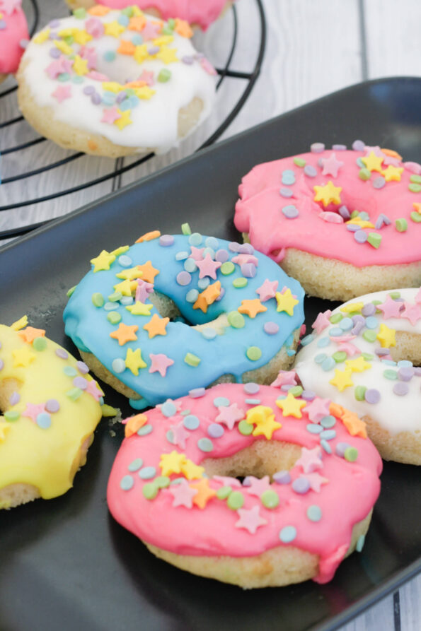 baked doughnuts on a black serving plate.