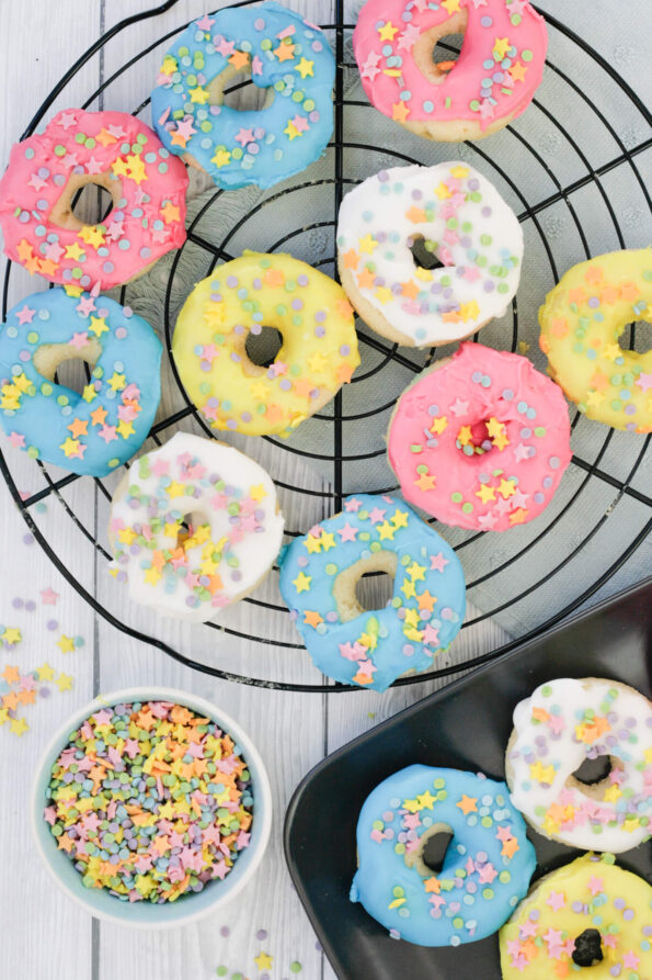 iced baked doughnuts on a wire rack.