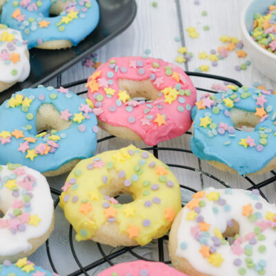 glazed baked doughnuts on a wire rack.