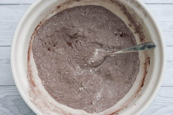 flour, cocoa, and sugar mixed together in a mixing bowl.